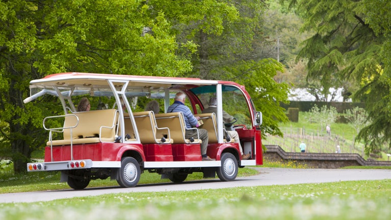 Visitors using the buggy at Knightshayes, Devon.